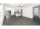 Open-concept living space featuring wood flooring, sliding glass doors, and a ceiling fan at 3832 Corsican Pl, Lake Alfred, FL 33850