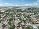 Scenic aerial perspective of a vibrant neighborhood near a lake, blending urban living with nature at 503 Holt Cir, Winter Haven, FL 33880