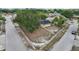 Aerial view of home with solar panels on a corner lot with mature tree, blue door, and black shutters at 503 Holt Cir, Winter Haven, FL 33880