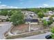 An aerial view shows the home with solar panels, a blue door, black shutters, and mature trees at 503 Holt Cir, Winter Haven, FL 33880