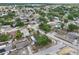 Residential aerial displays a variety of homes, mature trees, and community layout with proximity to local amenities at 503 Holt Cir, Winter Haven, FL 33880