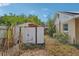 Backyard showcasing a storage shed, partial fence, and partial view of the home's exterior at 503 Holt Cir, Winter Haven, FL 33880