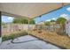Backyard showcasing a covered patio and fenced yard with landscaping potential at 503 Holt Cir, Winter Haven, FL 33880