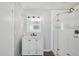 Modern bathroom with a vanity, glass door shower, and decorative lights at 503 Holt Cir, Winter Haven, FL 33880
