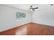 Bedroom with wood floors, ceiling fan, and large window at 503 Holt Cir, Winter Haven, FL 33880