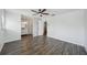 Spacious bedroom leading into an ensuite bathroom with modern dark wood-look floors at 503 Holt Cir, Winter Haven, FL 33880
