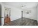 Bedroom with hardwood flooring and ceiling fan with access to closet and hall at 503 Holt Cir, Winter Haven, FL 33880