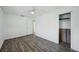 Bright bedroom features a ceiling fan, closet, and modern dark wood-look floors at 503 Holt Cir, Winter Haven, FL 33880