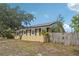 Exterior view of home showing solar panels, a fenced yard, and landscaping at 503 Holt Cir, Winter Haven, FL 33880