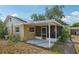 Exterior view of home featuring a screened-in patio, attached carport, and backyard at 503 Holt Cir, Winter Haven, FL 33880