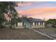 Charming home featuring solar panels, a welcoming turquoise door, and well-maintained landscaping at 503 Holt Cir, Winter Haven, FL 33880