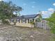 Exterior view of home showing solar panels, a fenced yard, and landscaping at 503 Holt Cir, Winter Haven, FL 33880