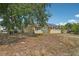 Exterior front view of the home with solar panels and natural landscaping at 503 Holt Cir, Winter Haven, FL 33880