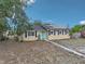 Charming single-story home featuring solar panels, a bright blue front door, and black shutters at 503 Holt Cir, Winter Haven, FL 33880