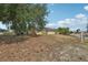 Street view of the home with solar panels and natural landscaping at 503 Holt Cir, Winter Haven, FL 33880