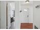 Hallway view of front door and updated bathroom with walk-in shower at 503 Holt Cir, Winter Haven, FL 33880