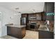 Well-lit kitchen with stainless steel appliances, granite counters, breakfast bar and ample cabinet space at 503 Holt Cir, Winter Haven, FL 33880