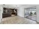 Eat-in kitchen boasts a breakfast bar, stainless appliances, granite counters, and screened-in patio access at 503 Holt Cir, Winter Haven, FL 33880