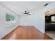 Bright living room with wood floors, ceiling fan, and large window at 503 Holt Cir, Winter Haven, FL 33880