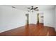 Bright living room with wood floors, ceiling fan, and multiple doorways at 503 Holt Cir, Winter Haven, FL 33880