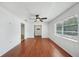 Bright living room with wood floors, ceiling fan, and large window at 503 Holt Cir, Winter Haven, FL 33880