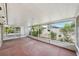 Enclosed screened porch with landscaping and plants along the sides at 503 Holt Cir, Winter Haven, FL 33880