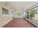 Enclosed screened porch with exit door overlooking exterior back yard at 503 Holt Cir, Winter Haven, FL 33880
