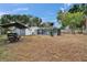 Spacious backyard featuring a screened pool area and boat on a trailer at 750 Azalea Dr, Bartow, FL 33830