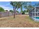 Large backyard surrounded by a wood fence, offering privacy and space for various outdoor activities at 750 Azalea Dr, Bartow, FL 33830