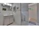 Bright bathroom with a vanity and a view of the shower with patterned tile flooring at 750 Azalea Dr, Bartow, FL 33830