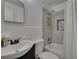 Bathroom featuring updated vanity, toilet, and shower with stylish gray tile, offering a modern and clean space at 750 Azalea Dr, Bartow, FL 33830