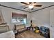 Bedroom currently used for storage, featuring a window and ample space for a bed and dresser at 750 Azalea Dr, Bartow, FL 33830