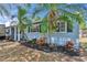 Charming exterior detail with manicured landscaping and healthy mature palms at 750 Azalea Dr, Bartow, FL 33830