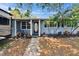 Inviting front entry with decorative door, landscaping, and freshly painted trim at 750 Azalea Dr, Bartow, FL 33830