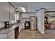 The kitchen features stainless steel appliances, light colored cabinets, and an open view into the living room at 750 Azalea Dr, Bartow, FL 33830