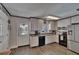 Bright kitchen with stainless steel appliances, white cabinets, and a door leading to the pool area at 750 Azalea Dr, Bartow, FL 33830