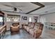 Living room featuring comfortable seating, natural light, wooden beams, and a view to the dining area at 750 Azalea Dr, Bartow, FL 33830