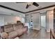 Spacious living room with comfortable seating, an entertainment center, and a bathroom on the side at 750 Azalea Dr, Bartow, FL 33830
