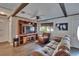 Cozy living room with wooden beams, built-in shelving, and comfortable seating, ideal for entertaining guests at 750 Azalea Dr, Bartow, FL 33830