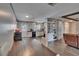 Open-concept room flows to the kitchen, featuring wood-look floors, built-in shelving and dining area at 750 Azalea Dr, Bartow, FL 33830