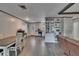 Open-concept room flows to the kitchen, featuring wood-look floors, built-in shelving and dining area at 750 Azalea Dr, Bartow, FL 33830