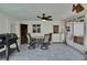 Relaxing outdoor space with ceiling fan, dining table, tile flooring, and white wainscoting walls at 750 Azalea Dr, Bartow, FL 33830