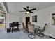 Outdoor dining area with ceiling fan and BBQ, providing an ideal setting for outdoor meals and relaxation at 750 Azalea Dr, Bartow, FL 33830