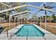 Sparkling in-ground pool surrounded by a screened enclosure and fenced yard provides a private outdoor oasis at 750 Azalea Dr, Bartow, FL 33830