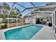 Relaxing screened-in pool and patio area for year-round enjoyment in the backyard at 750 Azalea Dr, Bartow, FL 33830