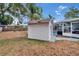 Backyard shed alongside a screened-in pool area, offering extra storage space and easy access to pool amenities at 750 Azalea Dr, Bartow, FL 33830