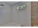 Bright shower with white tiles and a window view offering natural light and ventilation at 750 Azalea Dr, Bartow, FL 33830
