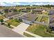 Aerial view of a home with a well-manicured lawn, fenced backyard, and a long driveway at 921 Fieldstone Way, Haines City, FL 33844