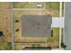 Aerial view showcasing a roof with dark shingles, surrounded by a well maintained lawn and white fence at 921 Fieldstone Way, Haines City, FL 33844