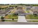 Aerial view of a home with a well-manicured lawn, fenced backyard, and a long driveway at 921 Fieldstone Way, Haines City, FL 33844
